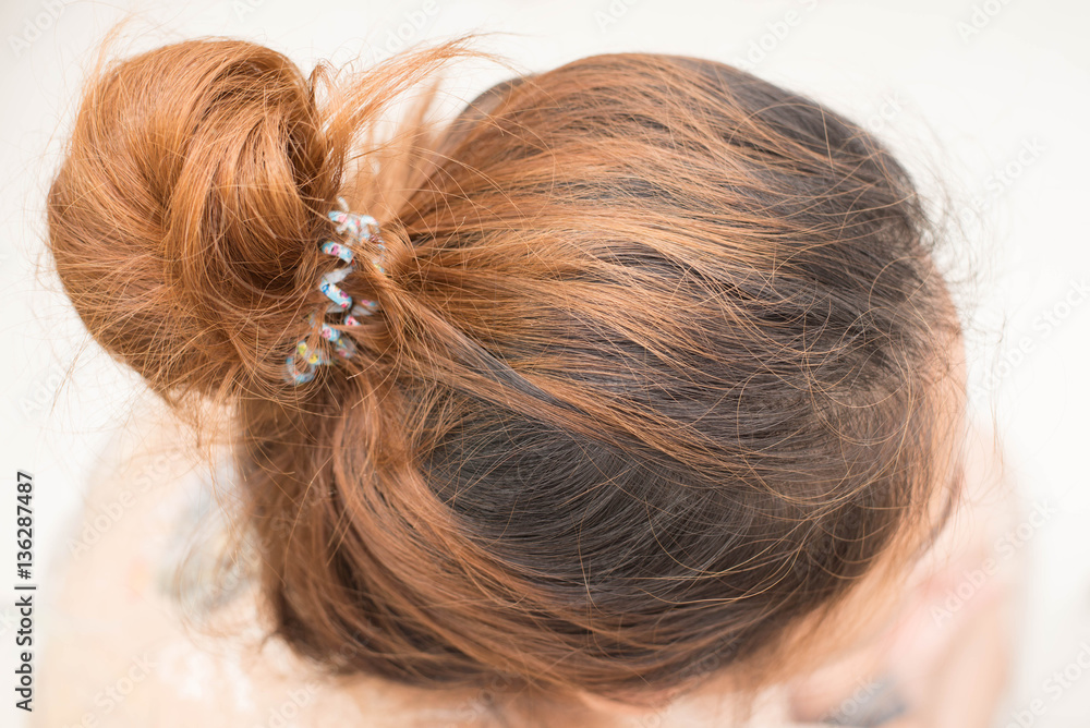 Top view of woman head with tied her hair. Top view of woman head with tied her hair.