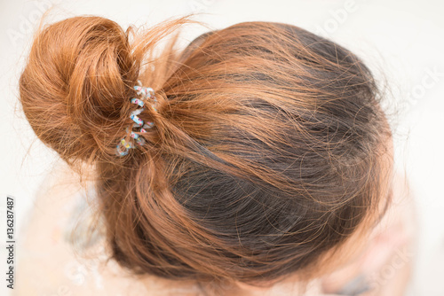 Top view of woman head with tied her hair.