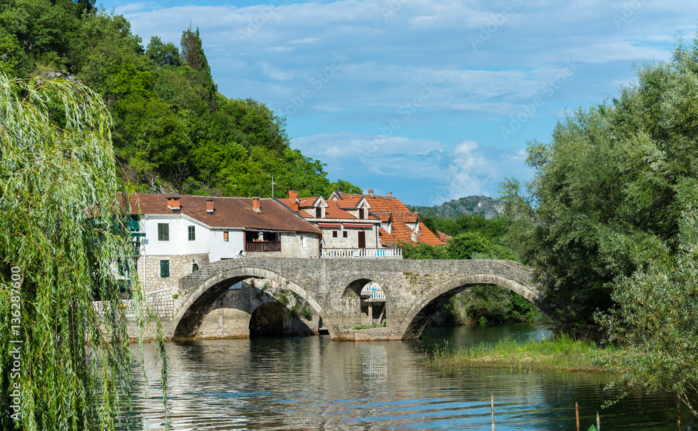 Old bridge and houses in the city of River Crnojevica. Bridge re