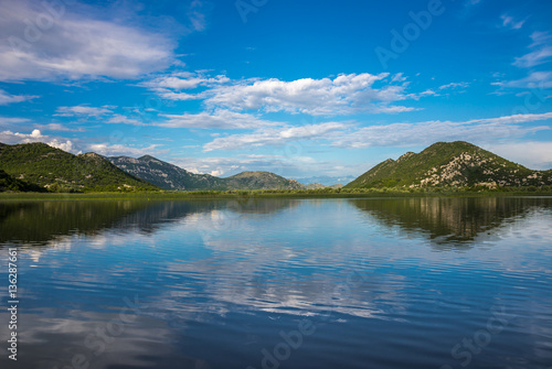 Beautiful scenery of Skadar Lake with reflection of mountains an