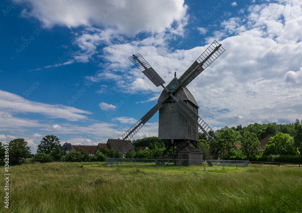 The old windmill in a village against sky The old windmill in a village against sky