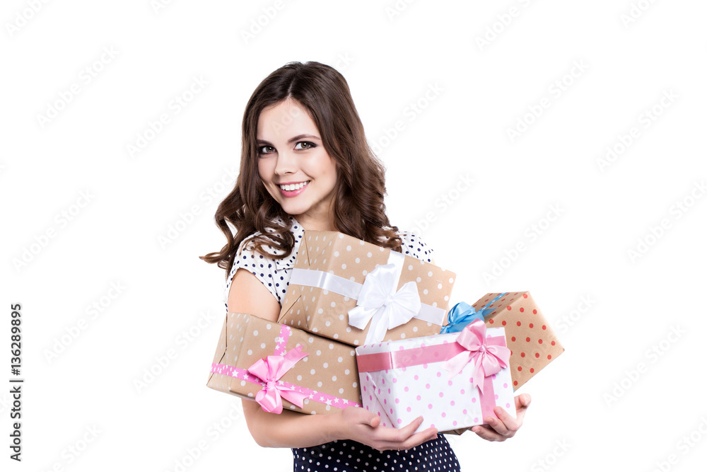 Beautiful smiling woman with gifts in polka-dot dress. Beautiful smiling woman with gifts in polka-dot dress.