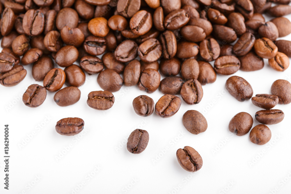 roasted coffee beans isolated in white background. Roasted coffee beans background close up. Coffee beans pile from top on white background with copy space for text. Good morning. roasted coffee beans isolated in white background. Roasted coffee beans background close up. Coffee beans pile from top on white background with copy space for text. Good morning.