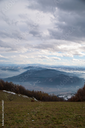 Panoramic view of the mountains covered in snow and fog