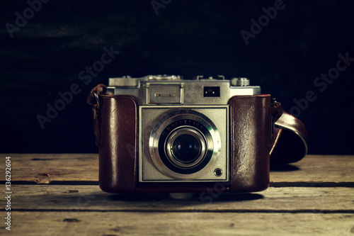 Old Vintage Camera on Dark Wooden Background. Horizontal with Co