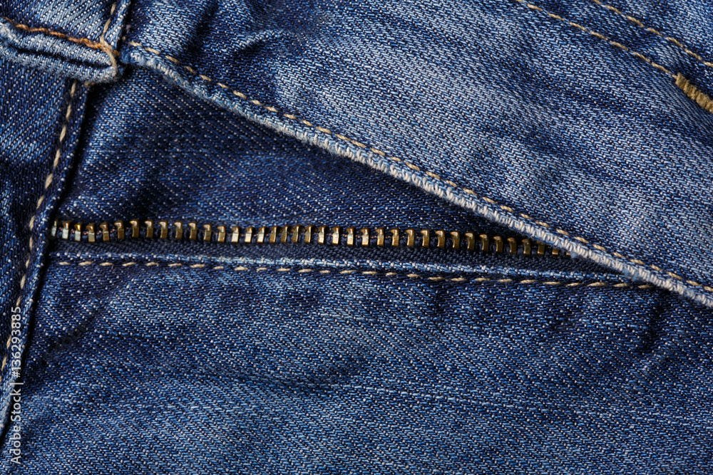 Denim jeans texture background with torn. The texture of the colored cotton fabric. Stitched texture jeans background. Fashion jeans button. Pocket and rivet on jeans. Fiber and fabric structure. Denim jeans texture background with torn. The texture of the colored cotton fabric. Stitched texture jeans background. Fashion jeans button. Pocket and rivet on jeans. Fiber and fabric structure.