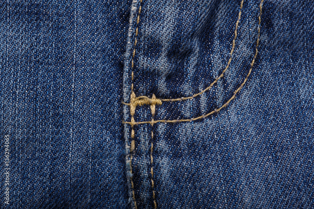 Denim jeans texture background with torn. The texture of the colored cotton fabric. Stitched texture jeans background. Fashion jeans button. Pocket and rivet on jeans. Fiber and fabric structure. Denim jeans texture background with torn. The texture of the colored cotton fabric. Stitched texture jeans background. Fashion jeans button. Pocket and rivet on jeans. Fiber and fabric structure.