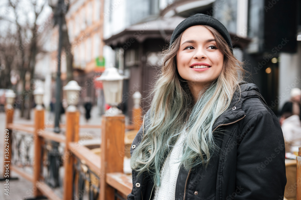 Pretty young lady wearing hat walking on the street Pretty young lady wearing hat walking on the street