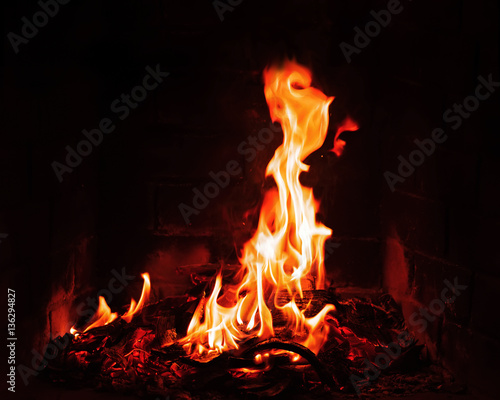 Fireplace burning. Warm burning and glowing fire in fireplace. Close up. Cozy background.