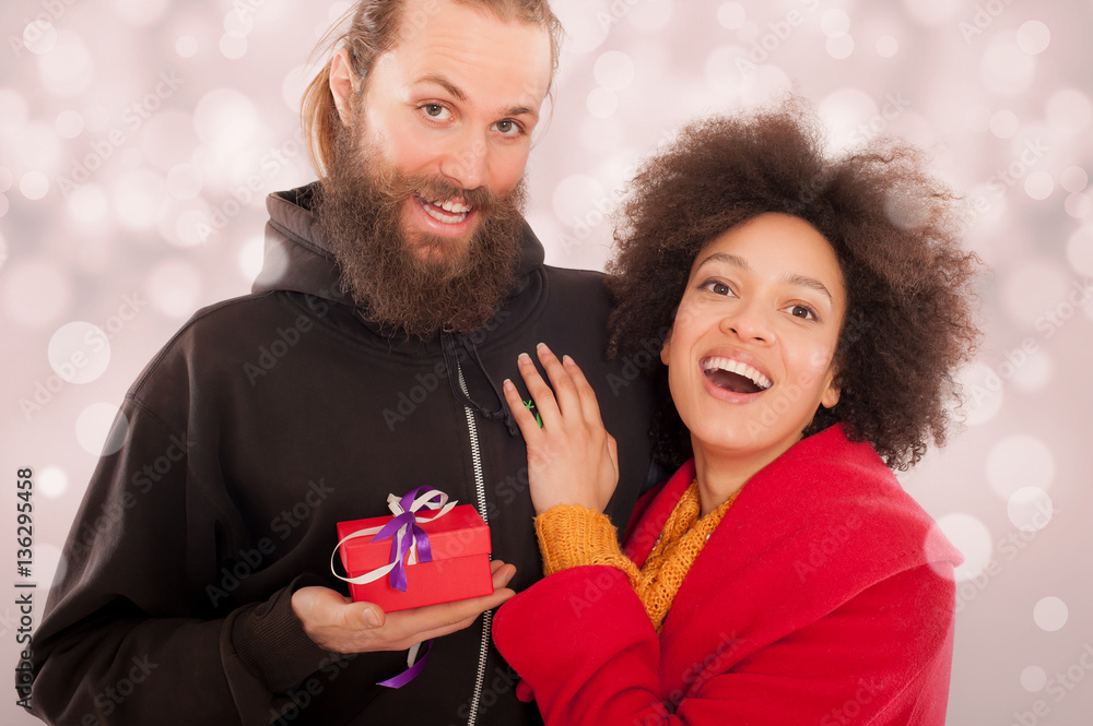 Beautiful young couple holding her gift box Beautiful young couple holding her gift box