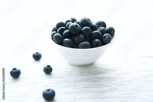 Blackberries in a white little bowl on a white background
