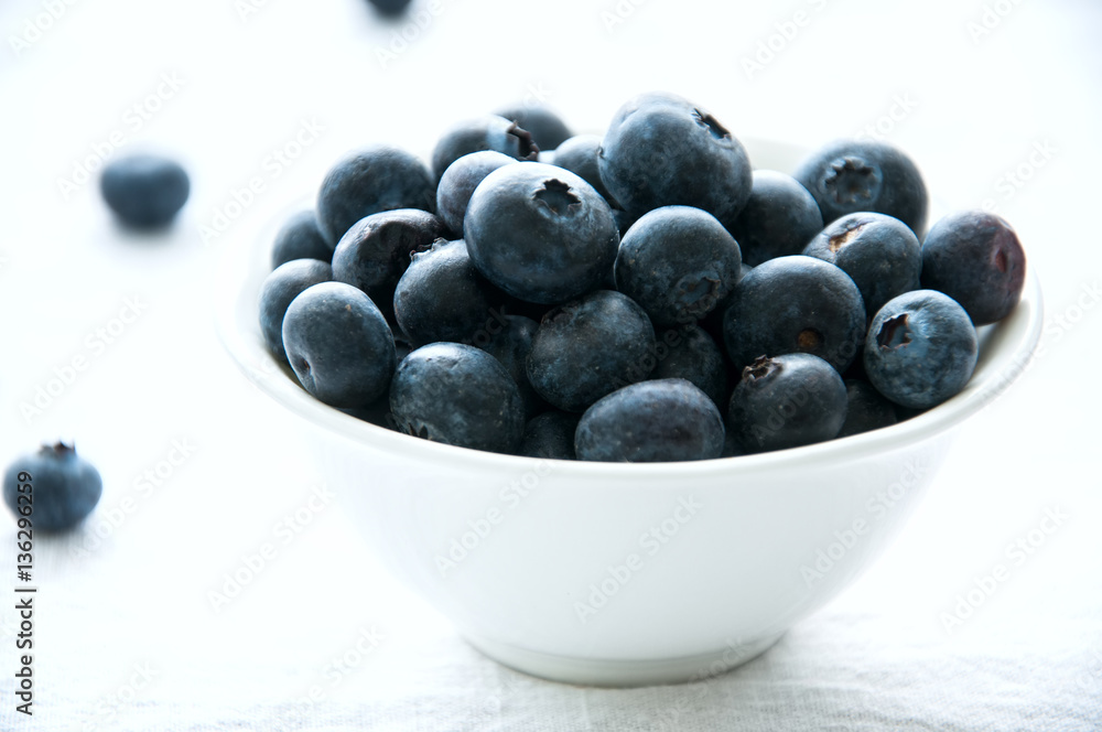 Blackberries in a white little bowl on a white background Blackberries in a white little bowl on a white background