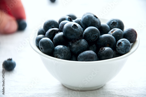 Blackberries in a white little bowl on a white background