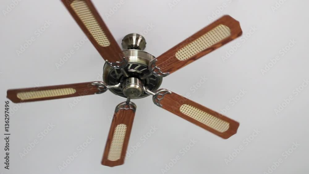 Ceiling fan spinning and rotating pushing down air for ventilation Ceiling fan spinning and rotating pushing down air for ventilation