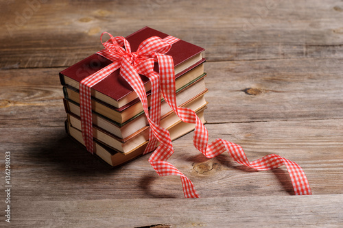 Books wrapped with color ribbon, on wooden table