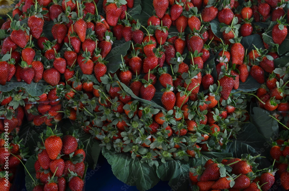 Fototapeta premium strawberries with leaves on the stall bazaar turkey