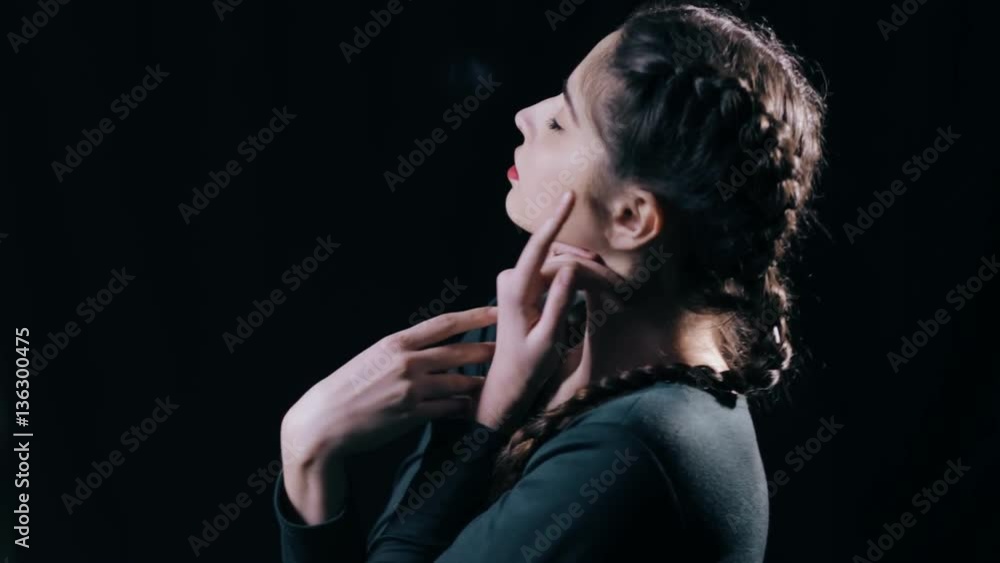 Woman gracefully moving on black background Woman gracefully moving on black background