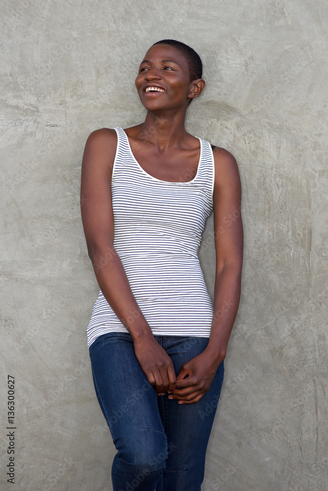 laughing attractive woman leaning against wall laughing attractive woman leaning against wall