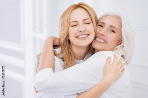 Quadro su tela Cheerul senior woman and her daughter embraing