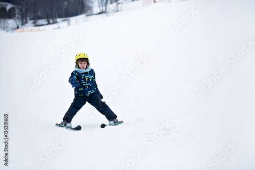Cute child, skiing in the mountain