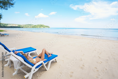 Fototapeta Naklejka Na Ścianę i Meble -  Tropical vacation concept. Young beautiful woman relaxing on the tropical  beach.