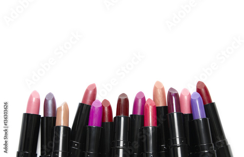 A variety of lipstick make up isolated on a white background with blank space above