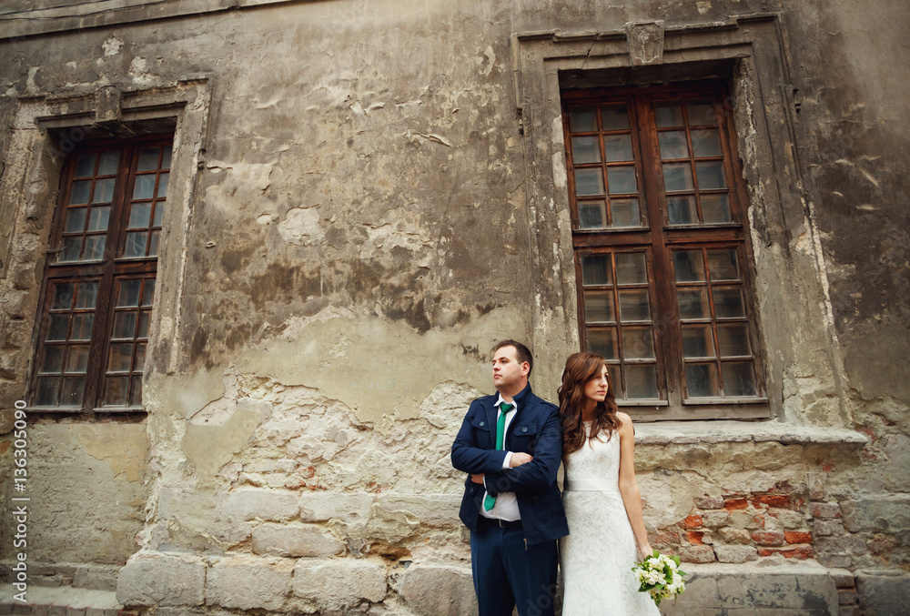 The lovely couple in love stand near building in italy
