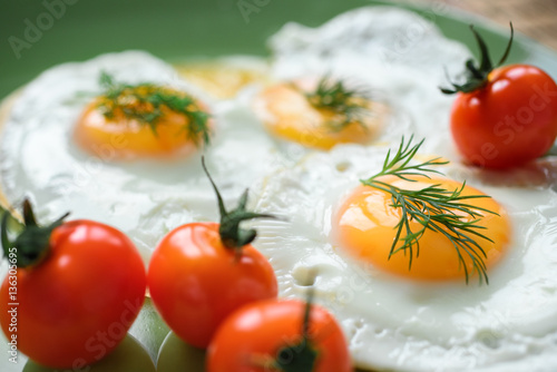 Delicious and healthy breakfast.  Fried egg with cherry tomatoes. ( Sunny side up ).  Selective focus