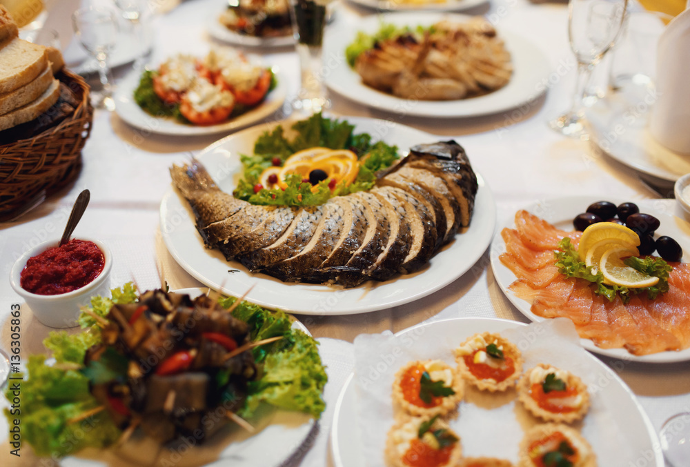 Festive table with fish and other specialties Festive table with fish and other specialties