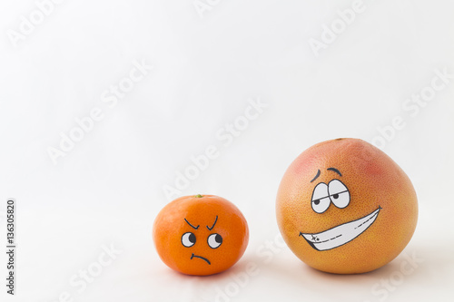Wallpaper Mural A big orange grapefruit and a tangerine with funny faces and white background Torontodigital.ca