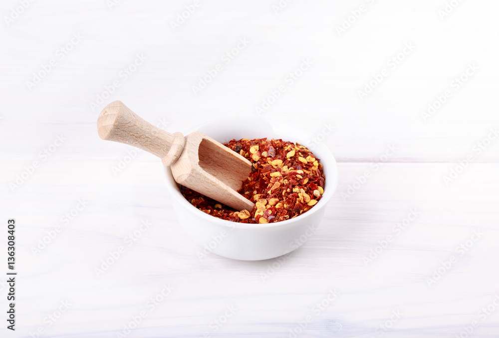 Red hot chili pepper flakes on white. Red hot chili pepper flakes on white.