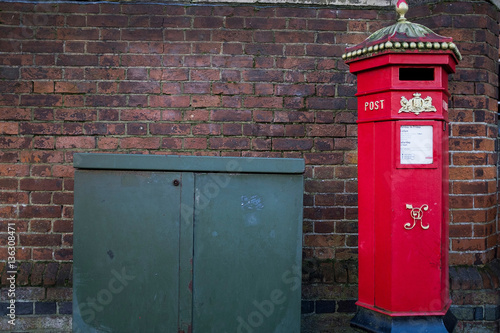 Tela Victorian red British postbox on urban street