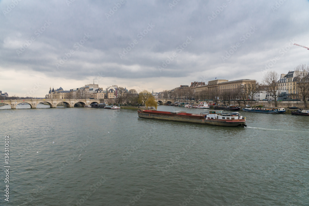 Paris, view of the Seine from the pont des Arts, with the Pont-Neuf and a barge crossing