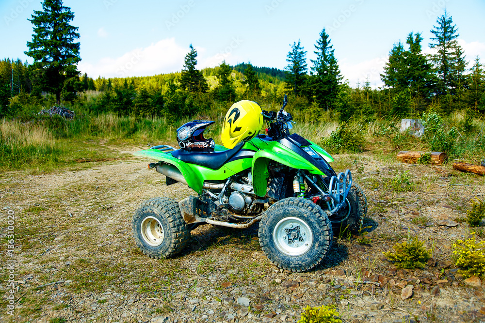 Green Quad in landscape on mountain road. Green Quad in landscape on mountain road.