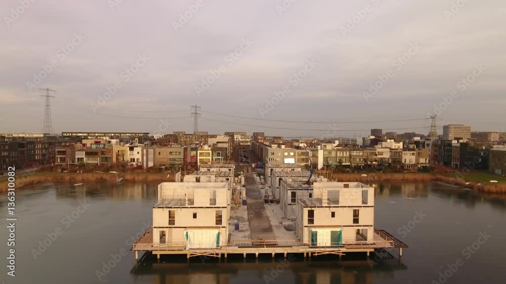 Newly built waterfront houses in Ijburg, Amsterdam. Aerial footage flying through street with houses under construction. Newly built waterfront houses in Ijburg, Amsterdam. Aerial footage flying through street with houses under construction.