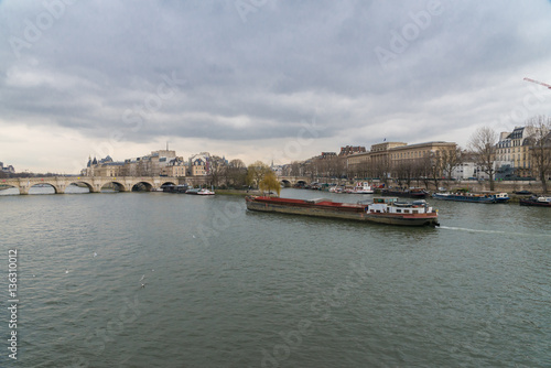 Paris, view of the Seine from the pont des Arts, with the Pont-Neuf and a barge crossing