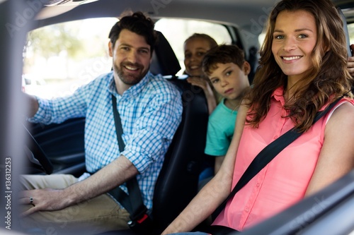 Happy family sitting in car