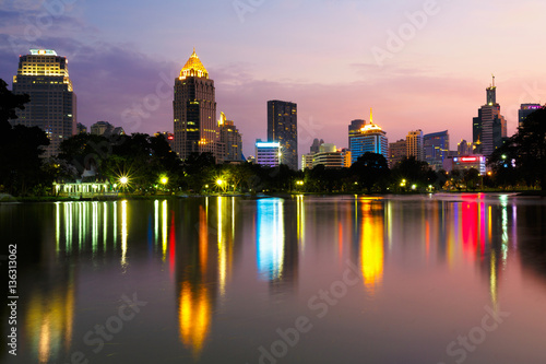 Business district cityscape from a park with twilight time from lumpini park  Bangkok Thailand