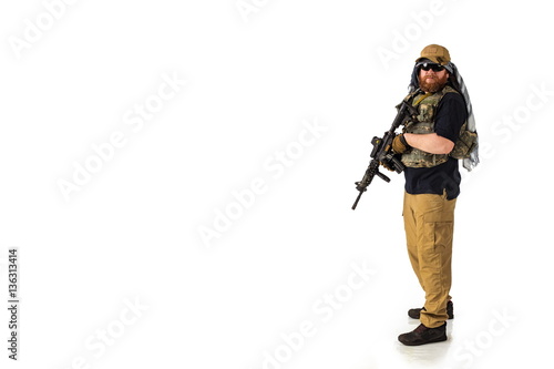 man in military outfit of the CIA, which is similar to the clothing of a warrior Mujahedin, in modern times on a white background in studio photo