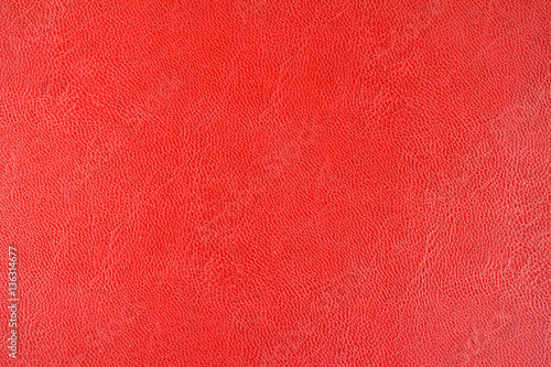 Red leather texture background, close up view.