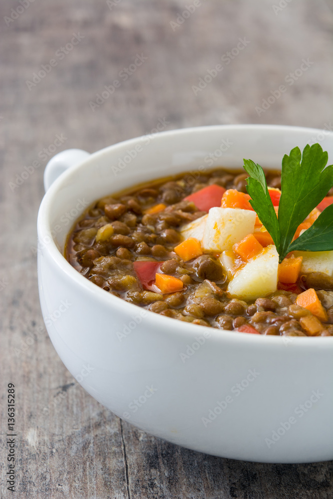 Lentil soup in a bowl on wooden background
Lentil soup in a bowl on wooden background