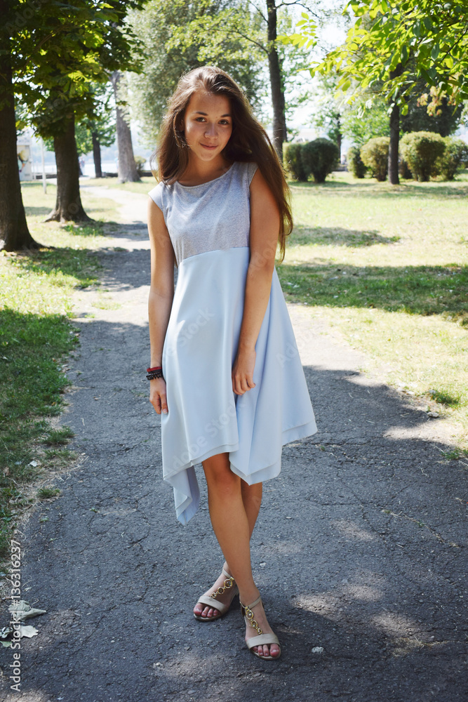 Portrait of beautiful teenage girl in blue blouse, against green Portrait of beautiful teenage girl in blue blouse, against green
