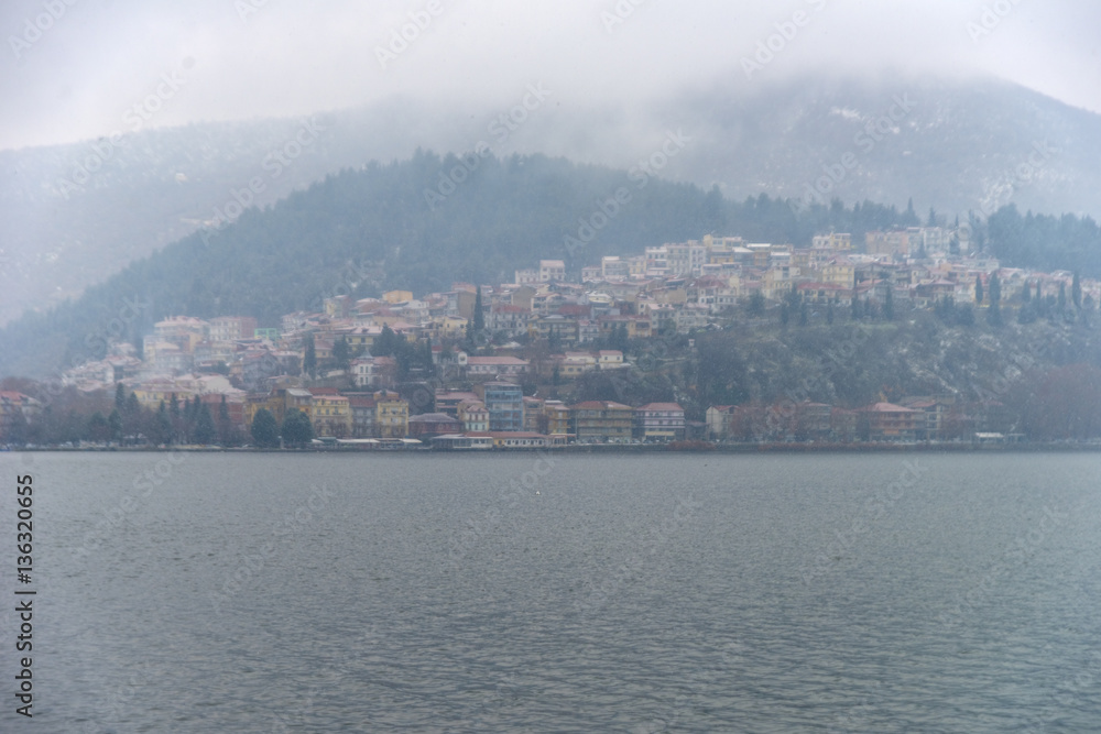 Foggy winter scenery at the lake of Kastoria Greece, during a he Foggy winter scenery at the lake of Kastoria Greece, during a he