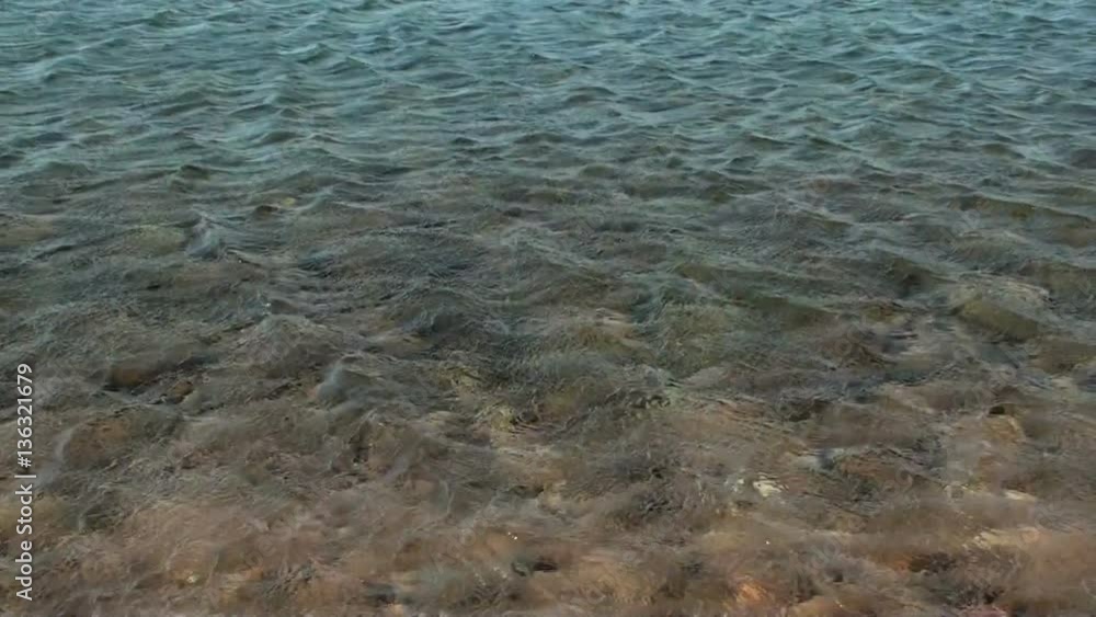 Curling water surface on a beach in sardinia,italy Curling water surface on a beach in sardinia,italy