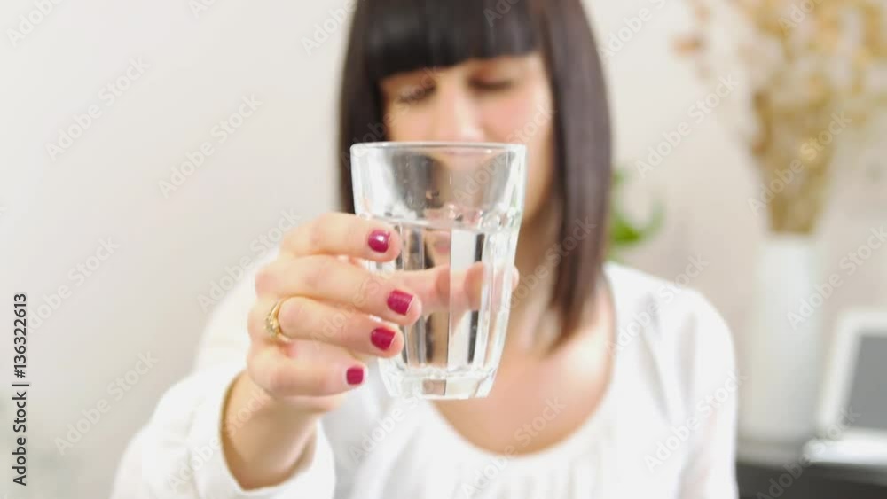 brunette girl with a headache, takes a pill brunette girl with a headache, takes a pill