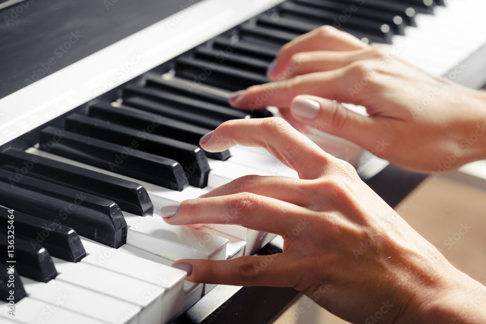Closeup of hands playing piano. Music and hobby concept Closeup of hands playing piano. Music and hobby concept