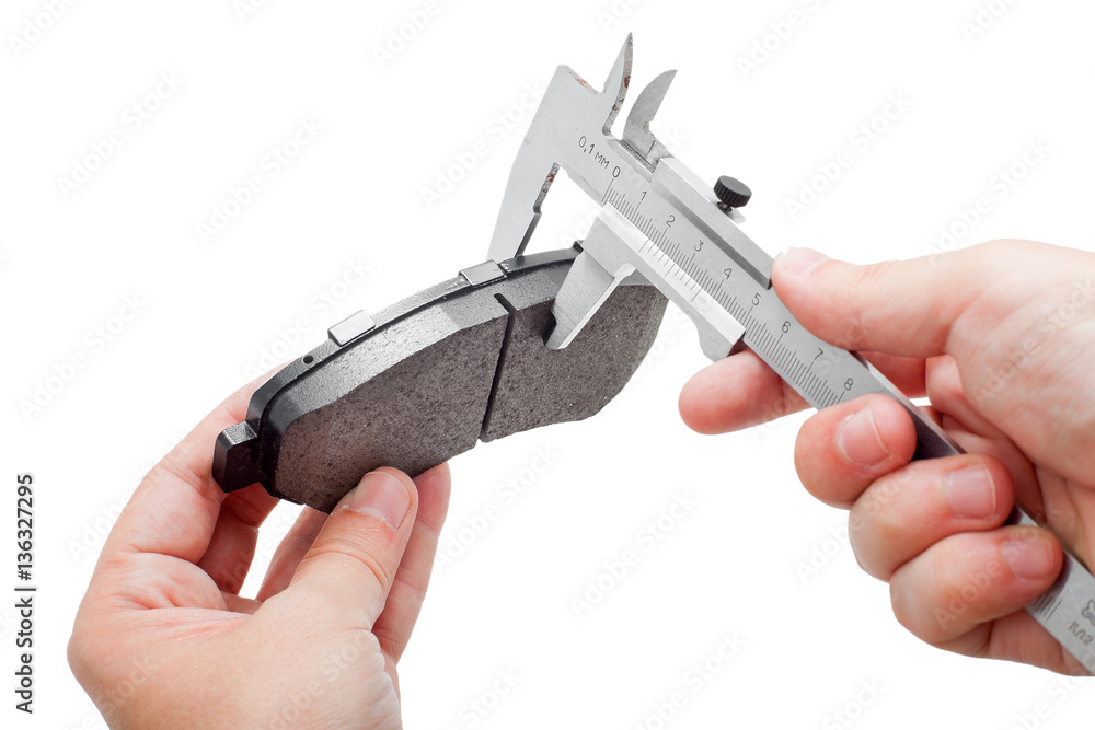 Fototapeta premium Brake pads with caliper on engineer hand.