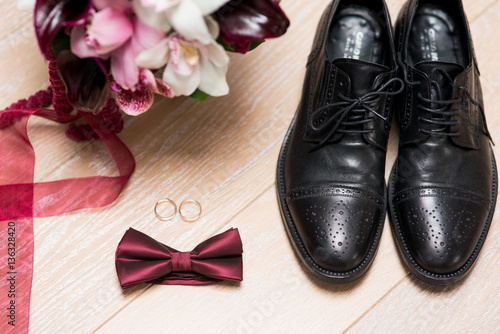 Groom accessories. Shoes, rings, belt, and bowtie