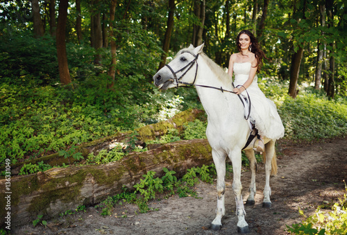 happy bride on a white horse © myronovychoksana