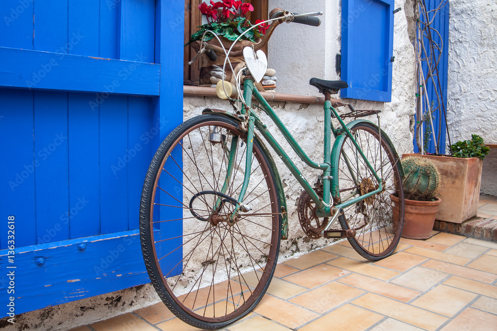 Vintage old bicycle in front of cute flowered house in Spain